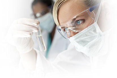 Female Scientist Inspecting Vial with Liquid